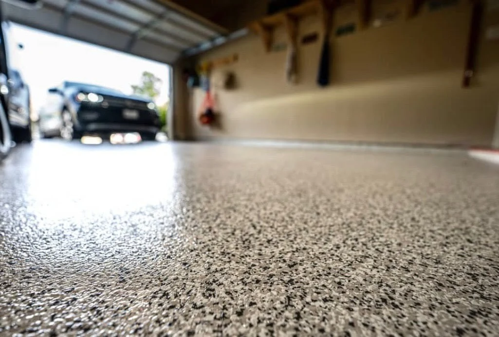 Epoxy-coated garage floor with full flake broadcast and glossy polyurethane finish installed by Integrity Coatings in Roanoke, Virginia.